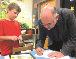 Jerry Barrett signing autograph for young student from the Wenz Elementary school in Paris Illinois.